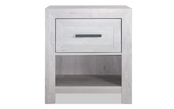 Calvin White Nightstand with Drawer from Calvin Bedroom collection, featuring engineered wood grain, contemporary style, plank look, felt-lined drawer, and open lower shelf for versatile storage.