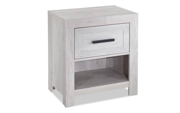 Calvin White Nightstand with Drawer from Calvin Bedroom collection, featuring engineered wood grain, contemporary style, felt-lined drawer, and open shelf.