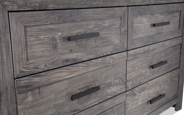 Calvin Gray 6 Drawer Dresser in engineered wood grain with a contemporary plank-style design, featuring six spacious drawers and black metal handles.