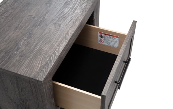 Calvin Gray Nightstand with Drawer from Calvin Bedroom collection, featuring engineered wood grain, contemporary plank-style design, and a felt-lined storage drawer with black handle.