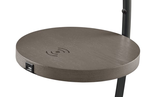 Contemporary Marco 67.5'' black metal LED floor lamp with vertical glow and integrated round wireless charging tray table in wood finish.