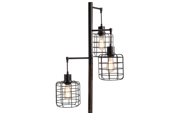Brooklyn Caged Motif 71'' Black Floor Lamp with three industrial-style metal cage shades on a black gilded post, providing warm ambient lighting.