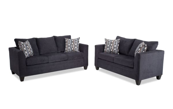 Stevie Charcoal 78'' Sofa and 65'' Loveseat set in gray polyester fabric, transitional style with flair arms, oversized seating, and patterned accent pillows.