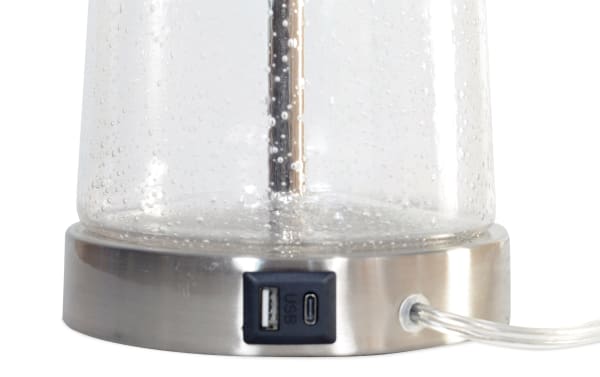 Rustic Anders Clear Seeded Glass Table Lamp base in chrome with white glass, featuring built-in USB and USB-C charging ports for device power.