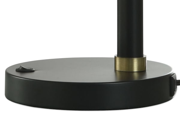 Blackened bronze metal base of Hunter contemporary table lamp with integrated on/off switch and gold accent ring, part of a beige linen set.