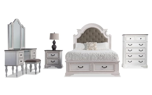 Scarlett 5 Piece King Bedroom Set in gray farmhouse style with upholstered fabric bed, oak storage platform, vanity with mirror, nightstand with USB, and chest with antique brass hardware. Made of birch veneers, poplar solids, MDF, and polyester fabric.