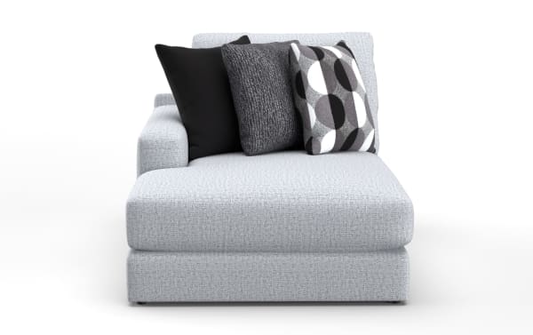 Light gray fabric chaise lounge with a left armrest, featuring three decorative throw pillows in black, dark gray, and a geometric black, white, and gray pattern.
