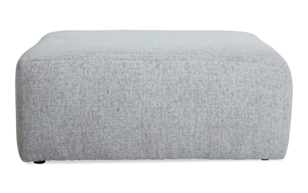 Transitional Mason White Cocktail Ottoman with soft polyester fabric upholstery, memory foam cushioning, and a neutral white color for versatile living spaces.