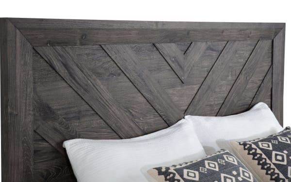 Gray wood grain chevron-patterned headboard from Calvin 5 Piece Queen Gray Panel Bedroom Set, transitional style with engineered MDF materials.