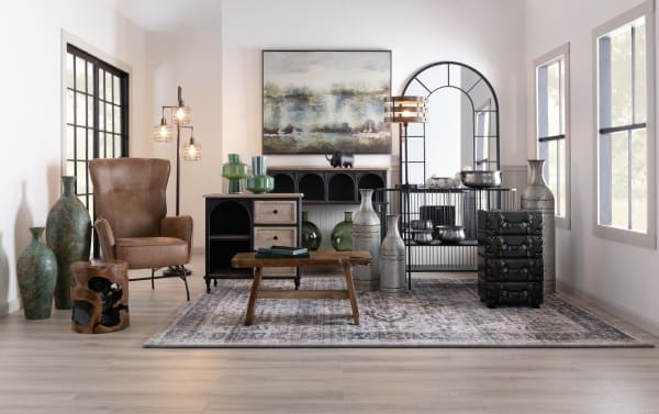 Rustic Arcadia Natural Solid Wood Coffee Table in teakwood with rough, organic texture, set in a modern living room with leather chair and decorative vases.