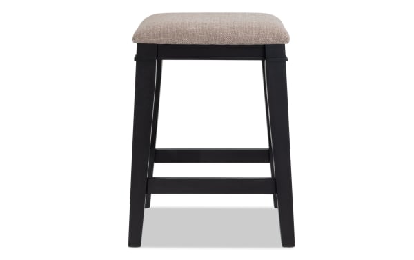 Montana Black & Beige Backless Upholstered Counter Height Stool with beige polyester fabric seat, rustic MDF frame, and memory foam cushion.