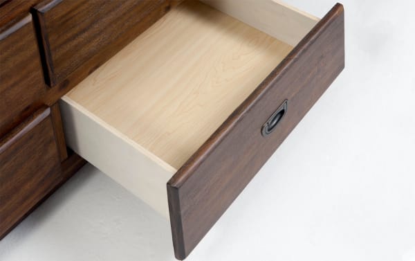 Open drawer of Chadwick Twin Brown Storage Captain Bed showing smooth light maple interior with dark brown MDF and poplar solid wood exterior, transitional style storage for clothing and shoes in kid’s bedroom.