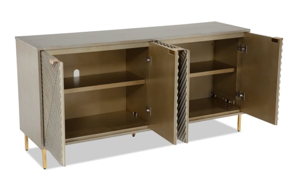 Brigitte Champagne Accent Cabinet in contemporary style with acacia veneers, champagne finish, reeded door design, and gold legs, featuring double doors and interior shelving for serveware storage.