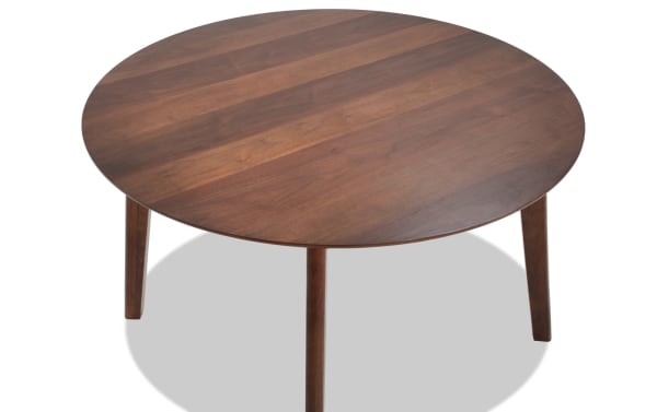 Mid-century modern Bettie Walnut Round Dining Table with flared legs, made from rubberwood solids, MDF, and walnut veneers in warm brown.