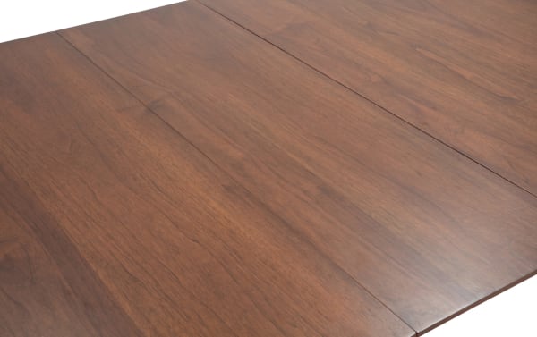 Mid-century modern Bettie Walnut Extendable Dining Table with smooth walnut veneer surface, flared legs, and a removable 12" leaf for extra space.