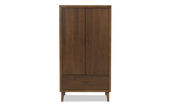Mid-century modern wooden wardrobe with two doors and a bottom drawer, featuring brass handles and tapered legs in a warm brown finish.