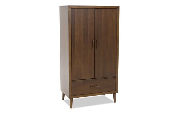 Mid-century modern wooden wardrobe with two doors, brass handles, tapered legs, and a lower drawer, in a warm walnut finish.