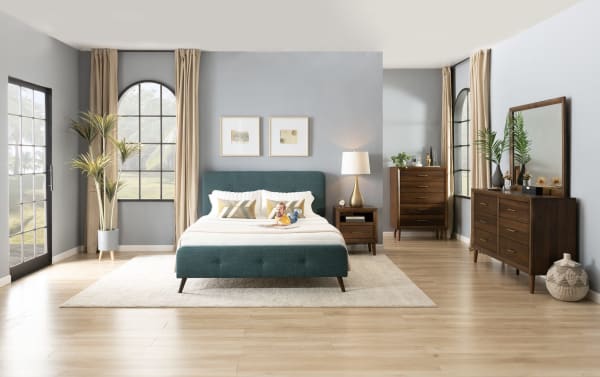 Mid-century modern Bettie Full Russet Upholstered Platform Bed in orange polyester fabric with flared legs and button tufting, styled in a bedroom setting.