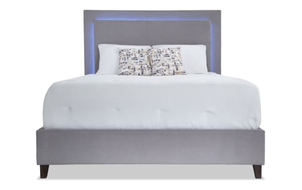 Performa Queen Gray Upholstered Panel Bed with plush polyester fabric, LED-lit gray headboard, rubberwood and engineered wood frame, contemporary style.