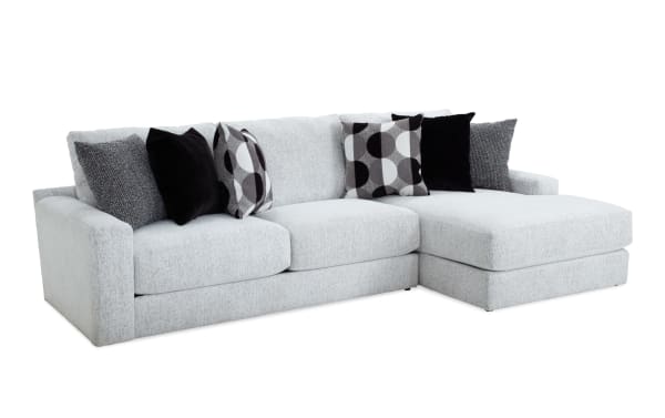 Mason White 123'' 2 Piece Right Arm Facing Chaise Sectional in white polyester fabric with six black and patterned accent pillows, transitional style.