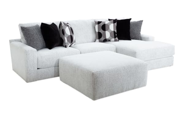Mason White 123'' 2-piece right arm facing chaise sectional with oversized ottoman, white polyester fabric, transitional style, includes six black and patterned accent pillows.