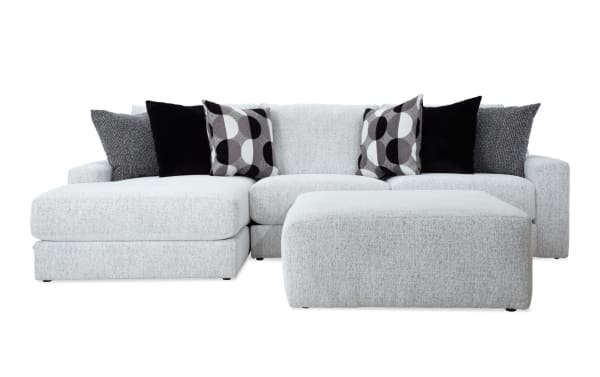 Mason White 123'' 2-piece left arm facing chaise sectional with oversized ottoman, white polyester fabric, transitional style, includes six black and patterned accent pillows.
