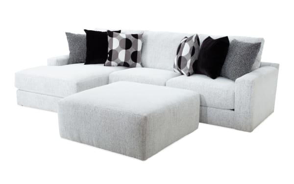 Mason White 123'' 2 Piece Left Arm Facing Chaise Sectional with Ottoman in white polyester fabric. Transitional style with six accent pillows, memory foam cushions, and oversized ottoman for comfortable family seating.