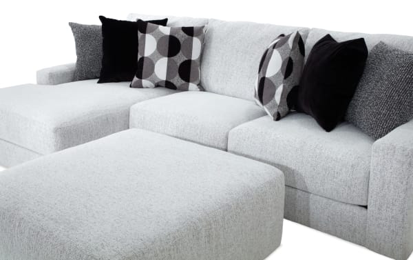 Mason White 123'' 2 Piece Left Arm Facing Chaise Sectional with oversized ottoman, transitional style, white polyester fabric, six accent pillows.