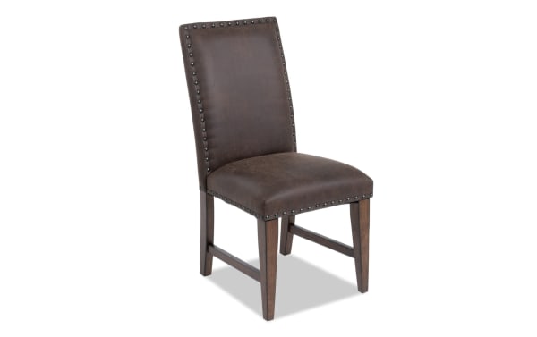 Canyon Brown Faux Leather Dining Chair with solid back, nailhead trim, and memory foam seat, rustic style from Canyon Dining collection.