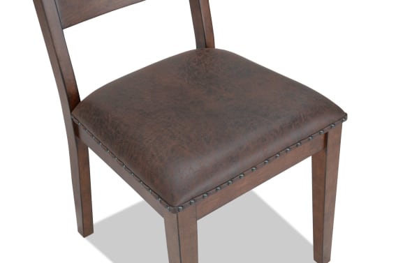 Canyon Brown Faux Leather Ladder Back Upholstered Dining Chair with rustic MDF wood frame, brown faux leather seat, and nailhead trim from Canyon Dining collection.