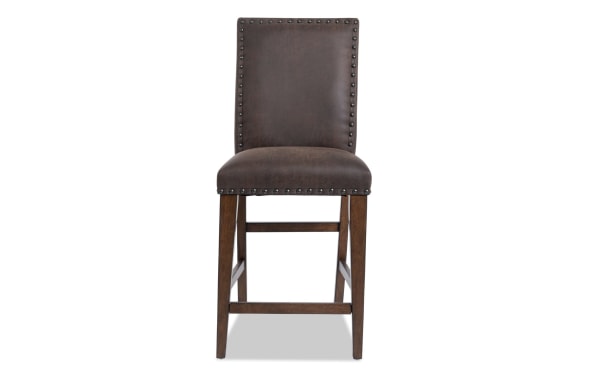 Canyon Brown faux leather solid back counter height stool with nailhead trim, memory foam seat, rustic style, and wooden legs from Canyon Dining collection.