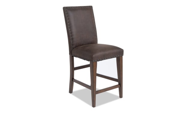 Canyon Brown faux leather counter height stool with solid back, nailhead trim, and rustic wood legs from the Canyon Dining collection.