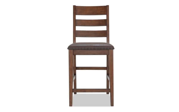 Canyon Brown Faux Leather Ladder Back Counter Height Stool with rustic brown MDF frame, cushioned faux leather seat, and ladder back design from Canyon Dining collection.