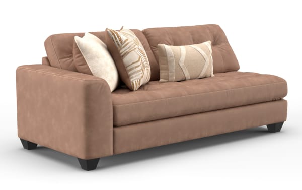 Modern brown leather sofa with tufted seat cushions, three decorative beige and patterned throw pillows, and black wooden legs, ideal for living room seating.