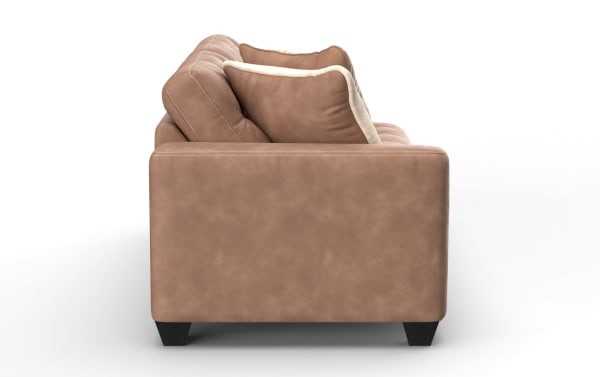 Brown leather sofa side view showing cushioned armrest, plush back pillows, and dark wooden legs, ideal for modern living rooms.