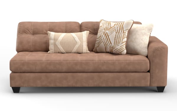 Modern brown leather sofa with tufted cushions, three decorative beige and patterned throw pillows, and black tapered legs.