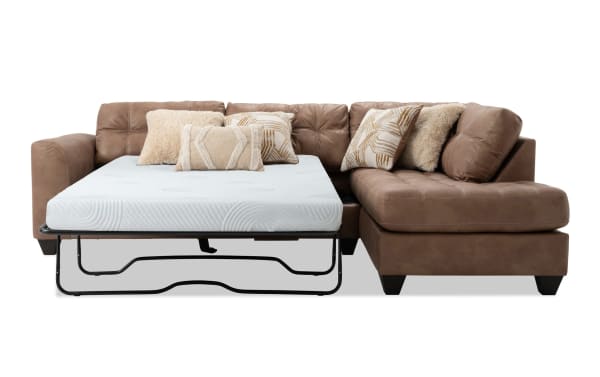 Sierra Cognac 118'' 2-piece right arm facing sleeper chaise sectional with tufted cushions, accent pillows, and full gel memory foam mattress in brown polyester fabric.