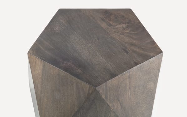 Contemporary Prism 17'' black mango wood side table with geometric pentagon shape, water-resistant finish, and hollow design for easy mobility.