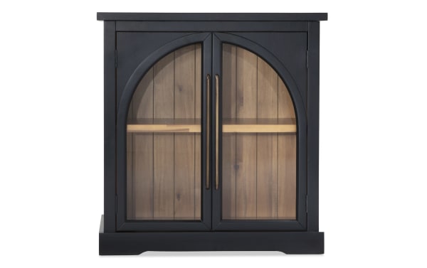 Black 2 Door Arch Cabinet in contemporary style, made of MDF with black frame, glass arch doors, and acacia plank back panel for display.