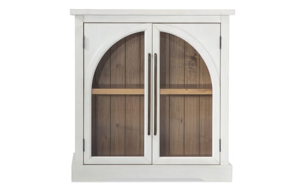 White 2 Door Arch Cabinet in contemporary style, made of MDF with glass arch doors showcasing acacia plank backing and interior shelf.