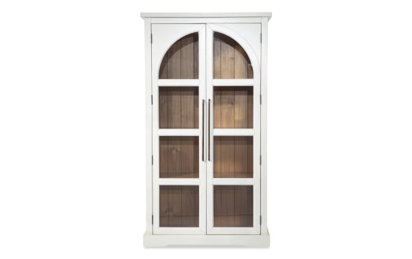 White 2 Door Tall Arch Cabinet in contemporary style, made of MDF with glass-paneled doors and acacia plank backing for display.