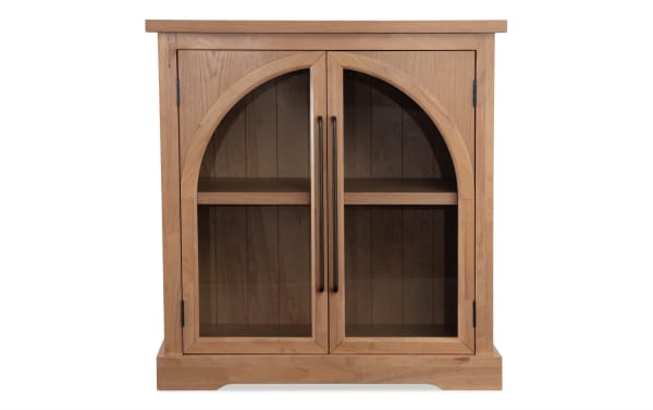 Natural 2 Door Arch Cabinet in contemporary style with MDF construction, natural wood finish, arched glass doors, and black metal handles for display storage.