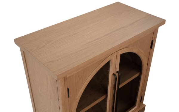 Natural 2 Door Arch Cabinet in natural wood MDF with contemporary style, featuring two arched glass display doors and black handles for showcasing decor.