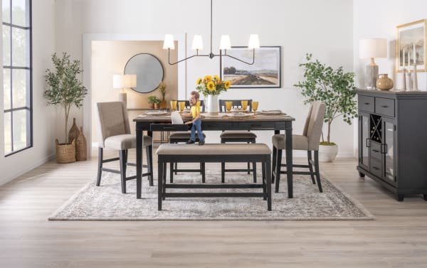 Montana Black & Brown Storage Dining Table in rustic style with six black rubberwood drawers, paired with cushioned beige chairs and bench, oak veneer top.