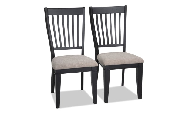 Set of 2 Montana Dining rustic chairs with black rubberwood slat backs and beige polyester fabric seats with memory foam cushioning.