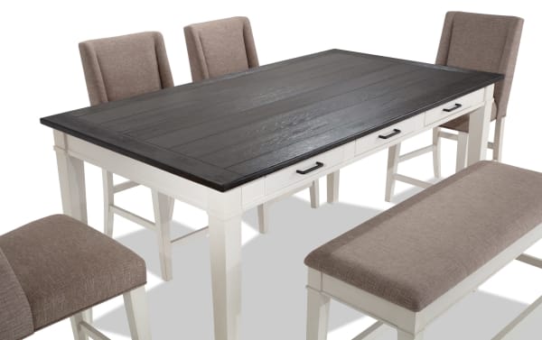 Montana 6 Piece Rustic Counter Height Dining Set with white rubberwood base, dark oak veneer top, beige polyester upholstered chairs, and storage bench with memory foam seating.