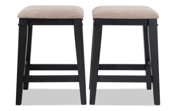 Set of 2 Montana Black & Beige Backless Upholstered Counter Height Stools with beige polyester fabric seats, black wooden MDF frames, rustic style.