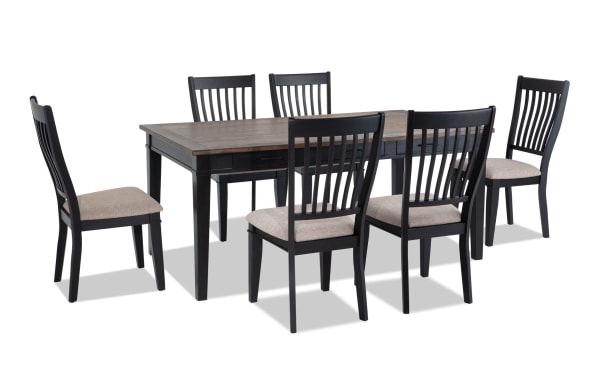 Montana 7 Piece Black & Beige Upholstered Dining Set with rustic rubberwood and oak veneer table, six storage drawers, and beige polyester fabric chairs with memory foam.