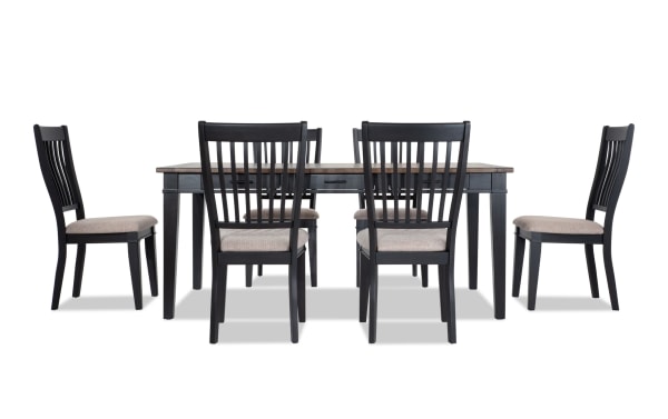 Montana 7 Piece Black & Beige Upholstered Dining Set with rustic rubberwood and oak veneer table, six storage drawers, and cushioned polyester fabric chairs.