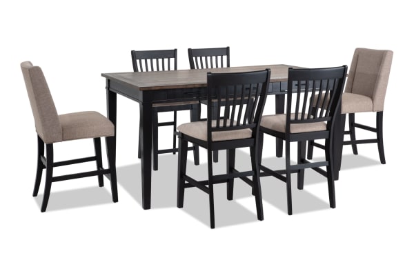 Montana 7 Piece Black & Beige Upholstered Counter Height Dining Set with rustic rubberwood, oak veneer table, six storage drawers, and beige polyester fabric chairs with memory foam cushions.